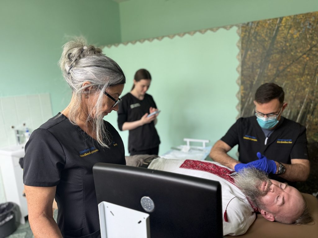 Dr. Lynch and Jodi performing an SGB in Kyiv while the patient wears a vyshyvanka