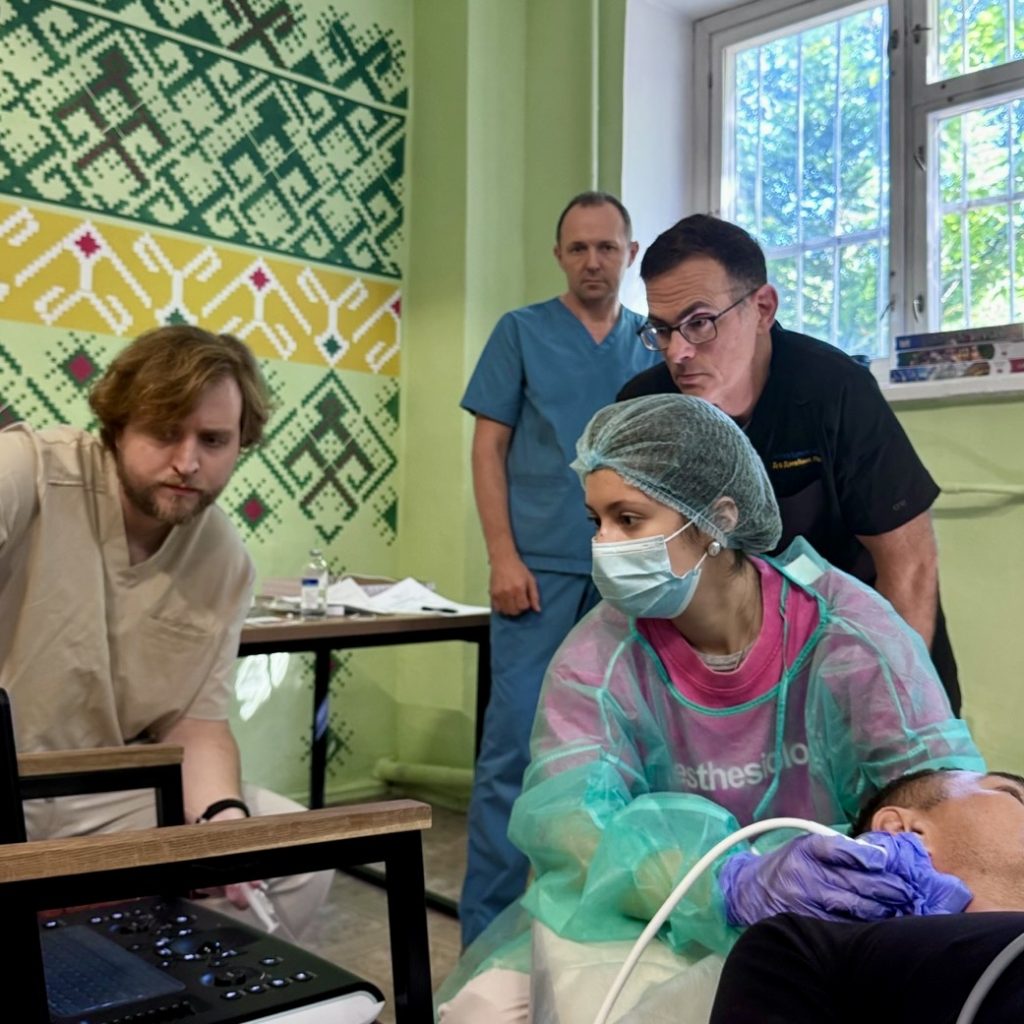 Ukrainian physician performing an ultrasound-guided SGB as Dr. Lynch and colleagues watch