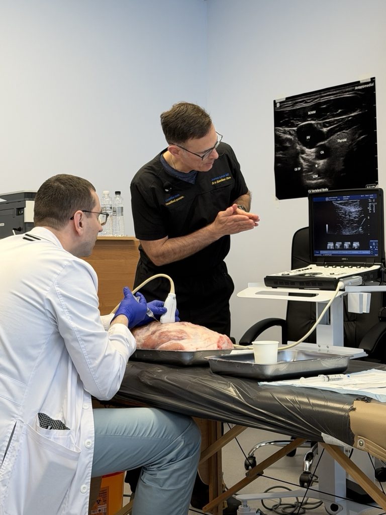 Ukrainian physician practicing ultrasound-guided needle placement on a tissue model